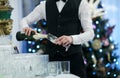Waiter pouring glasses of champagne