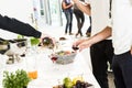 Waiter Pouring Red Wine Glass to Two Men on White Buffet Table Royalty Free Stock Photo