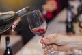 Waiter pouring red wine into glass. Royalty Free Stock Photo