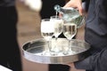 Waiter is pouring wine in the glass Royalty Free Stock Photo