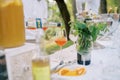 Waiter pours Aperol liqueur from a bottle into a glass on the table