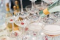 The waiter pours champagne into crystal glasses close up. Sparkling wine pouring in wine glass at summer day. Catering Royalty Free Stock Photo