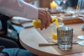 A waiter pours orange juice into a glass