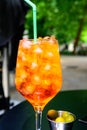 Waiter prepared the Aperol Sprits summer cocktail with Aperol, prosecco, ice cubes and orange in wine glass, ready to drink on Royalty Free Stock Photo