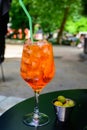 Waiter prepared the Aperol Sprits summer cocktail with Aperol, prosecco, ice cubes and orange in wine glass, ready to drink on Royalty Free Stock Photo