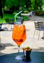 Waiter prepared the Aperol Sprits summer cocktail with Aperol, prosecco, ice cubes and orange in wine glass, ready to drink on Royalty Free Stock Photo