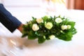 Waiter putting flowers on table