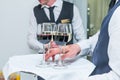 The waiter is servering catering tray with alcoholic and non-alcoholic drinks on the business event in the hall. Service at busine Royalty Free Stock Photo
