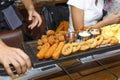 The waiter serves in the bar various snacks, beer and sauces. Chicken nuggets, chips, onion rings, fried chicken wings on a wooden Royalty Free Stock Photo