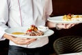 The waiter serves restaurant dishes Royalty Free Stock Photo