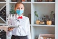 The waiter serves a table in a cafe in a protective mask Royalty Free Stock Photo