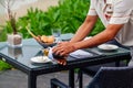 Waiter serves a table at a sea view restaurant Royalty Free Stock Photo