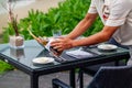 Waiter serves a table at a sea view restaurant Royalty Free Stock Photo