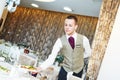 Waiter serving banquet table