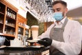 Waiter serving beverages in restaurant. Catering during coronavirus quarantine