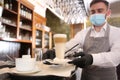 Waiter serving beverages in restaurant. Catering during coronavirus quarantine