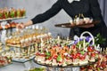 Waiter serving catering table