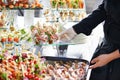 Waiter serving catering table Royalty Free Stock Photo