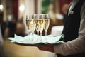 Waiter serving champagne on a tray at Royalty Free Stock Photo