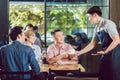 Waiter serving coffee to the customer Royalty Free Stock Photo