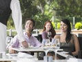 Waiter Serving Coffee To Young Couple At Cafe Royalty Free Stock Photo