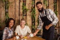 Waiter serving a cup of coffee to customer Royalty Free Stock Photo
