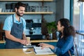 Waiter serving a cup of cold coffee to customer at table Royalty Free Stock Photo