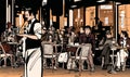 Waiter serving customers at traditional outdoor Parisian cafe