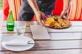 Waiter serving mexican nachos chips guacamole dip. Royalty Free Stock Photo