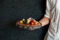 Waiter serving roasted Tuna Steaks Crusted with Herbs and grilled vegetable