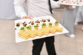 A waiter serving small appetizers at a wedding