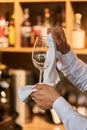 Waiter serving the table.Closeup of empty glass for wine, plate on the white tablecloth against break wall. Royalty Free Stock Photo