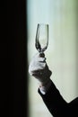 Waiter serving the table.Closeup of empty glass for wine, plate on the white tablecloth against break wall. Royalty Free Stock Photo