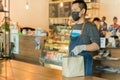 Waiter serving takeaway food to customer in small business social distance conceptual.