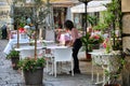 Waiter setting up restaurant terrace tables