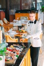 The waiter shifts the seafood on a tray in the restaurant.