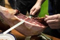 Waiter slicing serrano ham