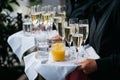 Waiter with sparkling wine, water and orange juice Royalty Free Stock Photo