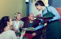 Waiter taking order at table of people Royalty Free Stock Photo