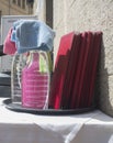 Waiter tray full of disinfectant spray products over restaurant terrace