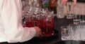 A waiter with a tray in his hands, on which there are many glasses with drinks. Royalty Free Stock Photo