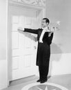 Waiter with tray knocking on a door Royalty Free Stock Photo