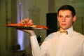 The waiter with the tray in a Russian restaurant.