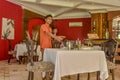 Waiter in uniform serving table