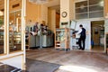 Waiter in uniform stands at the cash register in the old cafe Royalty Free Stock Photo