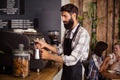 Waiter using a coffee machine