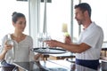 waiter and waitress holding serving tray Royalty Free Stock Photo