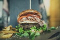 Waiter or Waitress Serving Burger in American BBQ Restaurant on Wooden Tray