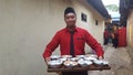 A waiter at a wedding reception is carrying the opening menu