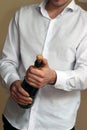 A Waiter in white shirt opens a Bottle of Champagne Royalty Free Stock Photo